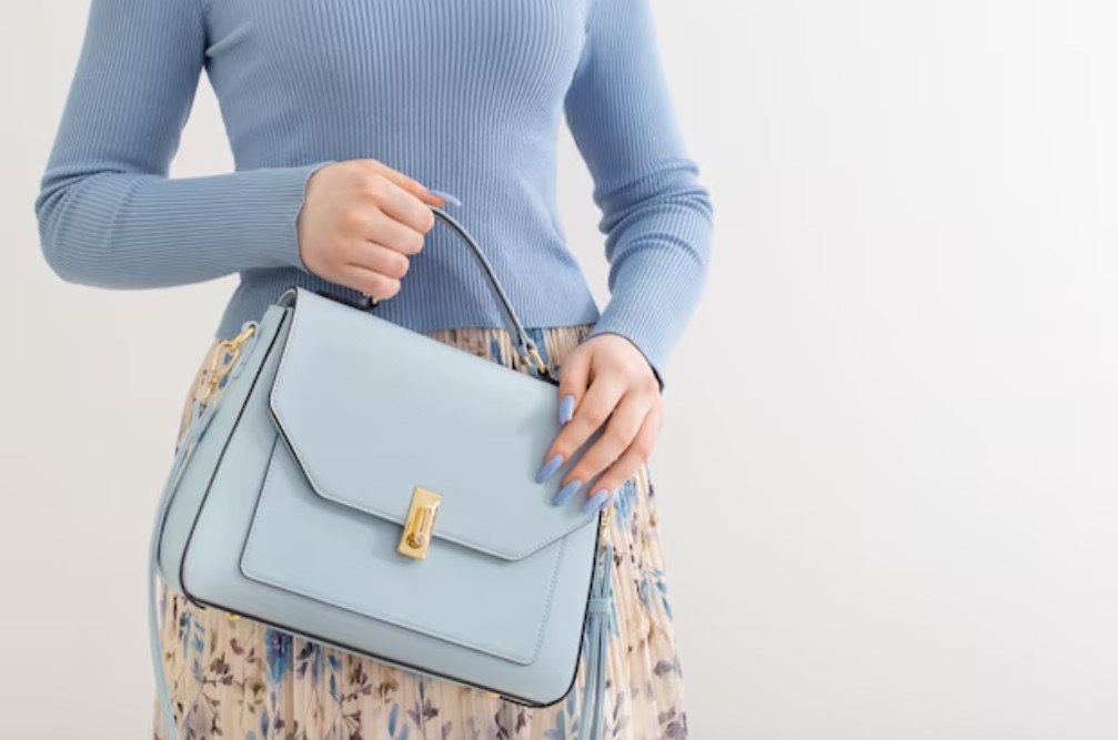 holding blue handbag