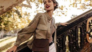 wavy-haired-woman-with-red-lips-with-handbag-posing-near-stairs